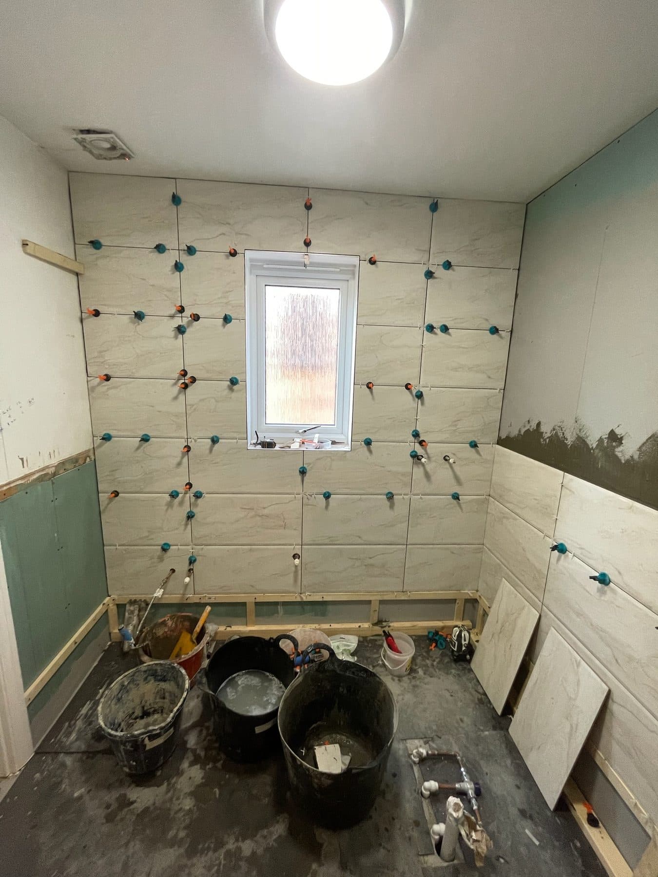 B5 — Bathroom window-wall tiling, construction progress